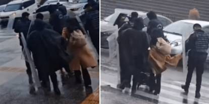 Fırtınada yürümekte zorlanan bebekli anneye çevik kuvvet polisinden kalkanlı destek